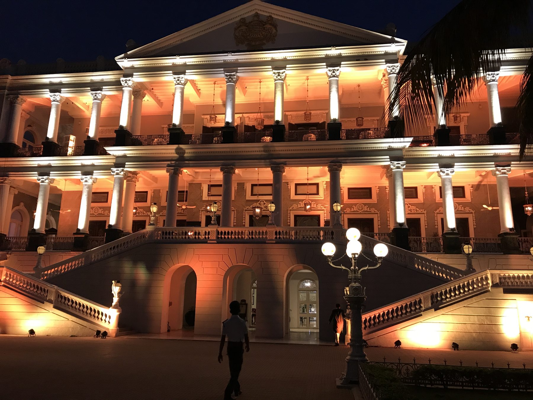 Palace facade lit in warm amber at night